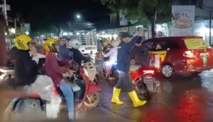 Personel Polsek Rappocini Perlancar Arus Lalu Lintas di Tengah Genangan Akibat Hujan